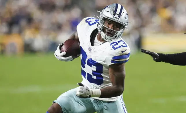 Dallas Cowboys running back Rico Dowdle runs with the gall against the Pittsburgh Steelers during the first half of an NFL football game, Sunday, Oct. 6, 2024, in Pittsburgh. (AP Photo/Matt Freed)