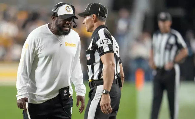 Pittsburgh Steelers head coach Mike Tomlin, left, talks to line judge Tim Podraza (47) during the first half of an NFL football game against the Dallas Cowboys, Sunday, Oct. 6, 2024, in Pittsburgh. (AP Photo/Gene J. Puskar)