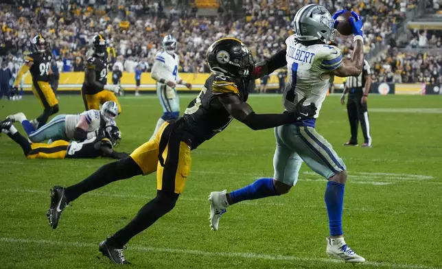 Dallas Cowboys wide receiver Jalen Tolbert (1) makes a touchdown catch as Pittsburgh Steelers safety DeShon Elliott tries to stop him during the second half of an NFL football game, early Monday, Oct. 7, 2024, in Pittsburgh. The Cowboys won 20-17. (AP Photo/Gene J. Puskar)