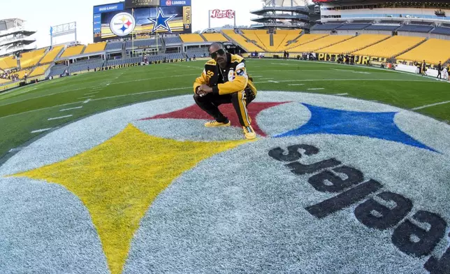 Snoop Dogg poses for photos prior to an NFL football game between the Pittsburgh Steelers and the Dallas Cowboys, Sunday, Oct. 6, 2024, in Pittsburgh. (AP Photo/Gene J. Puskar)