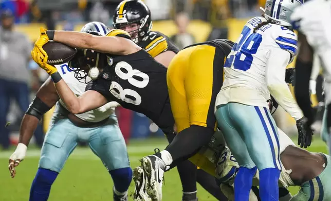 Pittsburgh Steelers tight end Pat Freiermuth (88) dives in for a touchdown on a pass from quarterback Justin Fields during the second half of an NFL football game against the Dallas Cowboys, early Monday, Oct. 7, 2024, in Pittsburgh. (AP Photo/Matt Freed)