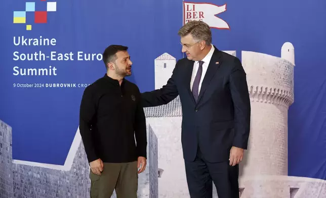 Ukrainian President Volodymyr Zelenskyy, left, is welcomed by Croatian Prime Minister Andrej Plenkovic at the Southeast Europe Croatia Ukraine summit in Dubrovnik, Croatia, Wednesday, Oct. 9, 2024. (Damir Sencar/Pool Photo via AP)