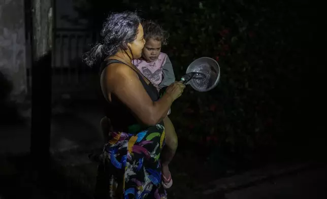 Residents protest by banging pots and pans in Havana, Cuba, Sunday, Oct. 20, 2024. (AP Photo/Ramon Espinosa)