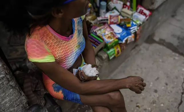 A street vendor selling candles waits for customers during a massive blackout following the failure of a major power plant in Havana, Cuba, Saturday, Oct. 19, 2024. (AP Photo/Ramon Espinosa)