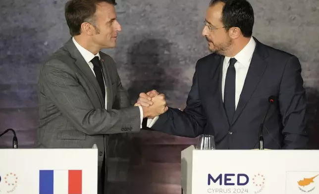 French President Emmanuel Macron, left, shakes hands with Cyprus' President Nikos Christodoulides, after the end of a press conference in Paphos, Cyprus, on Friday, Oct 11, 2024 as the leaders of nine southern European Union member countries and Jordan are meeting to come up with ways of de-escalating the conflict in the Middle East (AP Photo/Petros Karadjias)