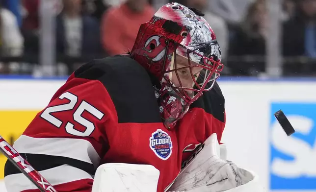 New Jersey goaltender Devils' Jacob Markstrom watches the puck during the NHL hockey game between Buffalo Sabres and New Jersey Devils, in Prague, Czech Republic, Friday, Oct. 4, 2024. (AP Photo/Petr David Josek)