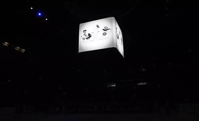 Screens show portraits of Johnny and Matthew Gaudreau during a moment of silence before the NHL hockey game between Buffalo Sabres and New Jersey Devils, in Prague, Czech Republic, Friday, Oct. 4, 2024. (AP Photo/Petr David Josek)