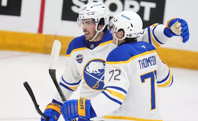 Buffalo Sabres' Owen Power, left, celebrates with Buffalo Sabres' Tage Thompson after scoring his side's first goal during the NHL hockey game between Buffalo Sabres and New Jersey Devils, in Prague, Czech Republic, Friday, Oct. 4, 2024. (AP Photo/Petr David Josek)