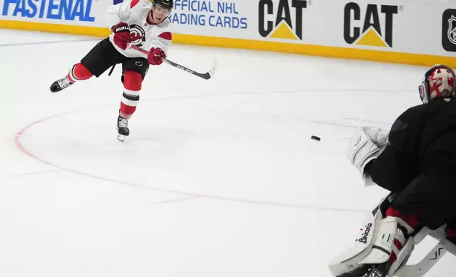 New Jersey Devils' Ondřej Palat takes a shot during a practice session, a day before their NHL hockey game against Buffalo Sabres, in Prague, Czech Republic, Thursday, Oct. 3, 2024. (AP Photo/Petr David Josek)