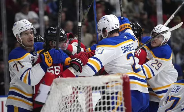 Players scuffle during the NHL hockey game between Buffalo Sabres and New Jersey Devils, in Prague, Czech Republic, Saturday, Oct. 5, 2024. (AP Photo/Petr David Josek)