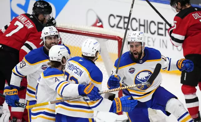 Buffalo Sabres' Tage Thompson, center, celebrates with teammates after scoring his sides first goal during the NHL hockey game between Buffalo Sabres and New Jersey Devils, in Prague, Czech Republic, Saturday, Oct. 5, 2024. (AP Photo/Petr David Josek)