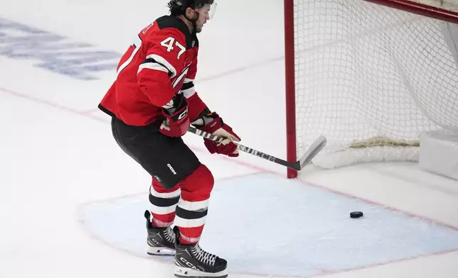 New Jersey Devils' Paul Cotter scores his side's fourth goal during the NHL hockey game between Buffalo Sabres and New Jersey Devils, in Prague, Czech Republic, Friday, Oct. 4, 2024. (AP Photo/Petr David Josek)