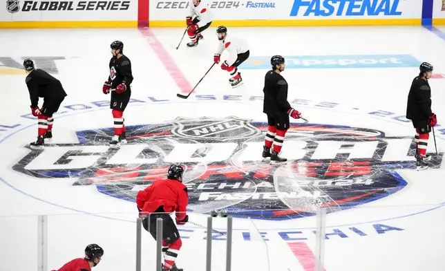 New Jersey Devils' attend a practice session, a day before their NHL hockey game against Buffalo Sabres, in Prague, Czech Republic, Thursday, Oct. 3, 2024. (AP Photo/Petr David Josek)