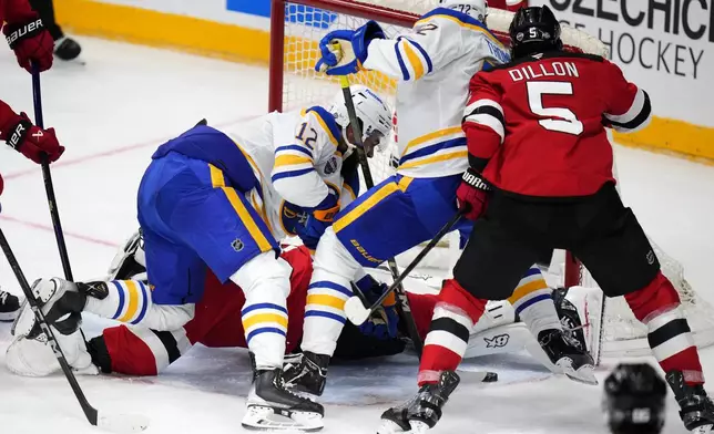 Buffalo Sabres' Tage Thompson, 2nd right, scores his sides first goal during the NHL hockey game between Buffalo Sabres and New Jersey Devils, in Prague, Czech Republic, Saturday, Oct. 5, 2024. (AP Photo/Petr David Josek)