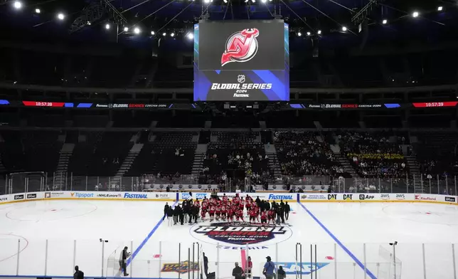 New Jersey Devils' players arrive for a practice session, a day before their NHL hockey game against Buffalo Sabres, in Prague, Czech Republic, Thursday, Oct. 3, 2024. (AP Photo/Petr David Josek)