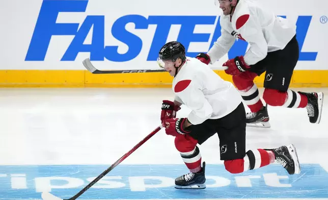 New Jersey Devils' Ondřej Palat speeds up during a practice session, a day before their NHL hockey game against Buffalo Sabres, in Prague, Czech Republic, Thursday, Oct. 3, 2024. (AP Photo/Petr David Josek)