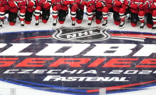 New Jersey Devils' players pose for a photo ahead of a practice session, a day before their NHL hockey game against Buffalo Sabres, in Prague, Czech Republic, Thursday, Oct. 3, 2024. (AP Photo/Petr David Josek)