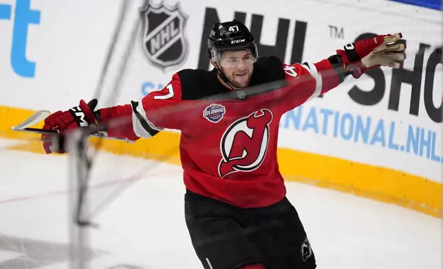 New Jersey Devils' Paul Cotter celebrates after scoring his sides second goal during the NHL hockey game between Buffalo Sabres and New Jersey Devils, in Prague, Czech Republic, Saturday, Oct. 5, 2024. (AP Photo/Petr David Josek)