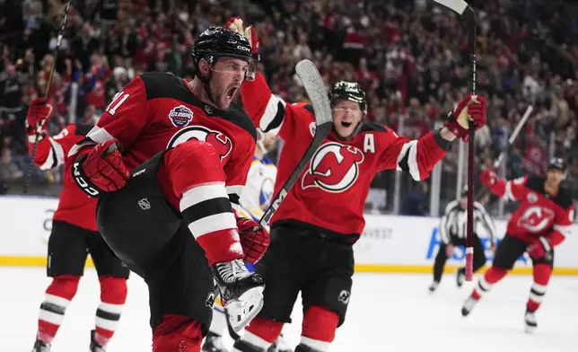 New Jersey Devils' Stefan Noesen, left, celebrates after scoring the opening goal during the NHL hockey game between Buffalo Sabres and New Jersey Devils, in Prague, Czech Republic, Friday, Oct. 4, 2024. (AP Photo/Petr David Josek)