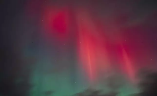 The northern lights are seen over Haraldsted Lake near Ringsted, Thursday, October 10, 2024.. (Mads Claus Rasmussen/Ritzau Scanpix via AP)