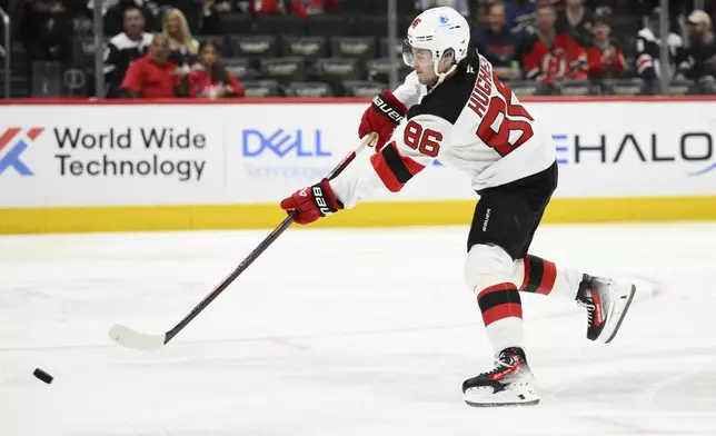 New Jersey Devils center Jack Hughes (86) shoots the puck during the second period of an NHL hockey game against the Washington Capitals, Saturday, Oct. 12, 2024, in Washington. (AP Photo/Nick Wass)