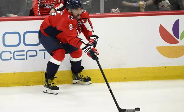 Washington Capitals left wing Alex Ovechkin (8) handles the puck during the third period of an NHL hockey game against the New Jersey Devils, Saturday, Oct. 12, 2024, in Washington. The Devils won 5-3. (AP Photo/Nick Wass)