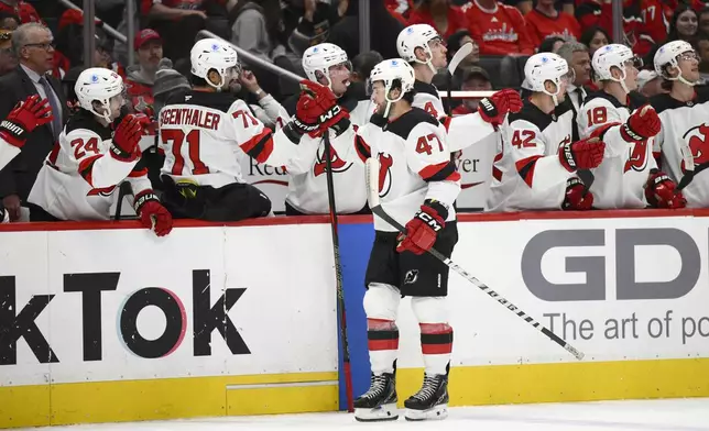 New Jersey Devils center Paul Cotter (47) celebrates his goal during the first period of an NHL hockey game against the Washington Capitals, Saturday, Oct. 12, 2024, in Washington. (AP Photo/Nick Wass)