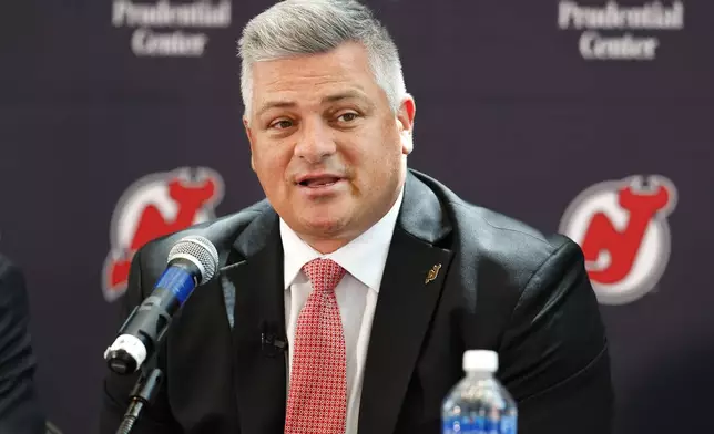 FILE - New Jersey Devils NHL hockey team new head coach Sheldon Keefe answers questions from reporters during press conference Tuesday, May 28, 2024, in Newark, N.J. (AP Photo/Noah K. Murray, File)