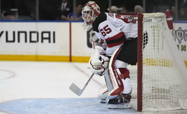 New Jersey Devils goalie Isaac Poulter stands on the ice during the second period of an NHL preseason hockey game against the New York Rangers, Tuesday, Oct. 1, 2024, in New York. (AP Photo/Pamela Smith)