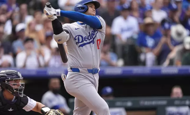 Los Angeles Dodgers' Shohei Ohtani follows the flight of his single off Colorado Rockies pitcher Seth Halvorsen in the eighth inning of a baseball game Sunday, Sept. 29, 2024, in Denver. (AP Photo/David Zalubowski)