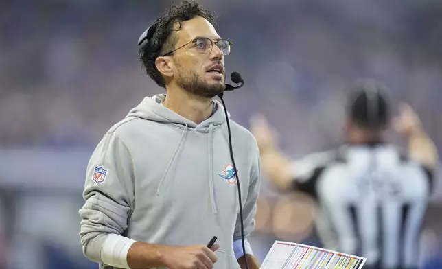 Miami Dolphins head coach Mike McDaniel prepares to call for a time out during the first half of an NFL football game against the Indianapolis Colts, Sunday, Oct. 20, 2024 in Indianapolis. (AP Photo/Michael Conroy)