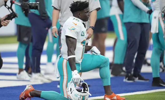 Miami Dolphins wide receiver Tyreek Hill stretches out before the start of an NFL football game against the Indianapolis Colts, Sunday, Oct. 20, 2024 in Indianapolis. (AP Photo/Michael Conroy)