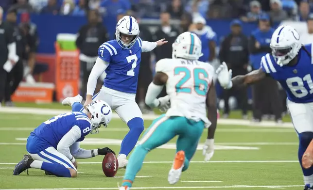 Indianapolis Colts place kicker Matt Gay (7) kicks a field goal as punter Rigoberto Sanchez (8) holds during the first half of an NFL football game against the Miami Dolphins, Sunday, Oct. 20, 2024 in Indianapolis. (AP Photo/Michael Conroy)