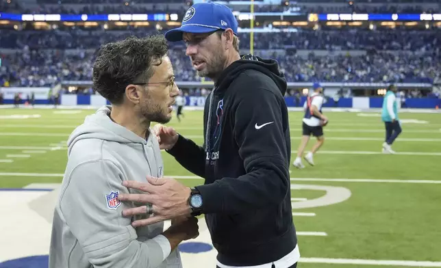 Indianapolis Colts head coach Shane Steichen, right, and Miami Dolphins head coach Mike McDaniel congratulate each other after an NFL football game, Sunday, Oct. 20, 2024 in Indianapolis. (AP Photo/Michael Conroy)