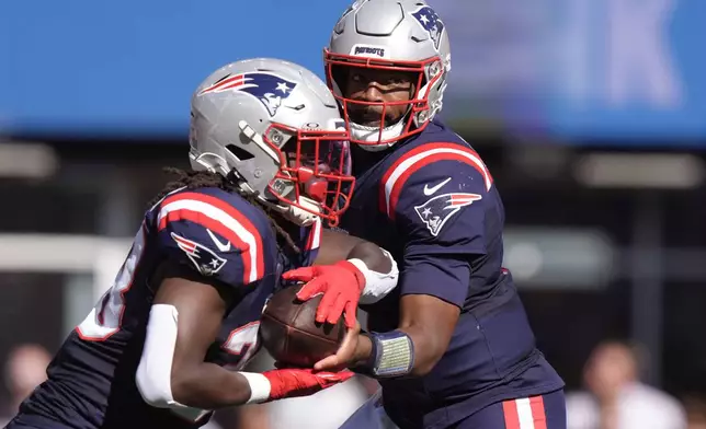 New England Patriots quarterback Jacoby Brissett (7) hands off to running back Rhamondre Stevenson during the first half of an NFL football game against the Miami Dolphins, Sunday, Oct. 6, 2024, in Foxborough, Mass. (AP Photo/Steven Senne)