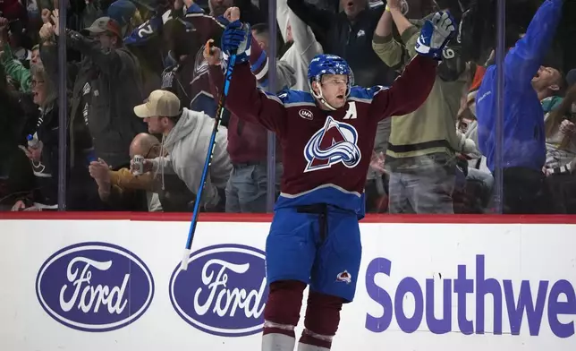 Colorado Avalanche center Nathan MacKinnon celebrates after scoring the winning goal in overtime of an NHL hockey game against the Anaheim Ducks Friday, Oct. 18, 2024, in Denver. (AP Photo/David Zalubowski)