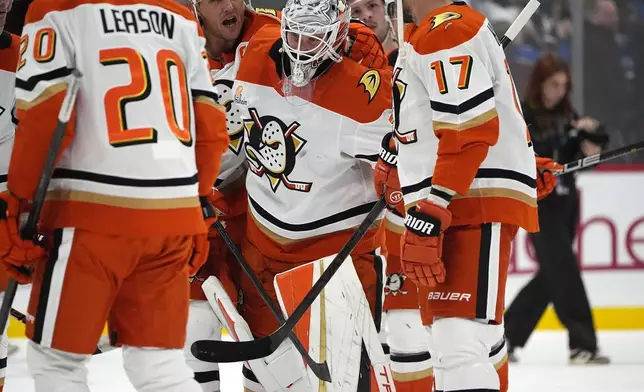 Anaheim Ducks goaltender Lukas Dostal, center front, heads off the ice after giving up the winning goal to Colorado Avalanche center Nathan MacKinnon in overtime of an NHL hockey game Friday, Oct. 18, 2024, in Denver. (AP Photo/David Zalubowski)