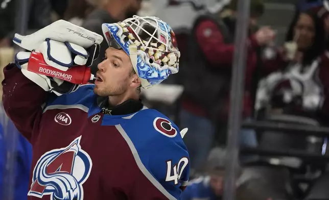 Colorado Avalanche goaltender Alexandar Georgiev drinks during a timeout in the second period of an NHL hockey game against the Anaheim Ducks, Friday, Oct. 18, 2024, in Denver. (AP Photo/David Zalubowski)