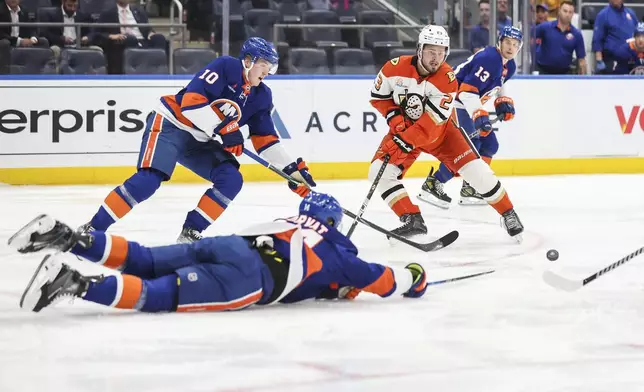 Anaheim Ducks' Mason McTavish goes after the puck with New York Islanders' Simon Holmstrom also in pursuit during the second period of an NHL hockey game, Tuesday, Oct. 29, 2024 in Elmont, N.Y. (AP Photo/Heather Khalifa)