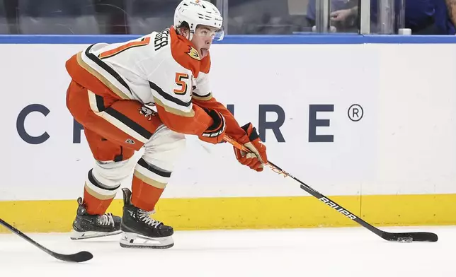 Anaheim Ducks' Olen Zellweger reaches out for the puck during the first period of an NHL game against the New York Islanders, Tuesday, Oct. 29, 2024 in Elmont, N.Y. (AP Photo/Heather Khalifa)