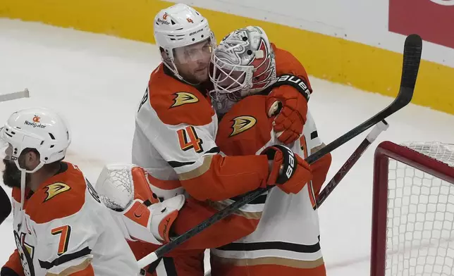 Anaheim Ducks defenseman Cam Fowler (4) celebrates with goaltender Lukas Dostal after the Ducks defeated the San Jose Sharks in an NHL hockey game in San Jose, Calif., Saturday, Oct. 12, 2024. (AP Photo/Jeff Chiu)