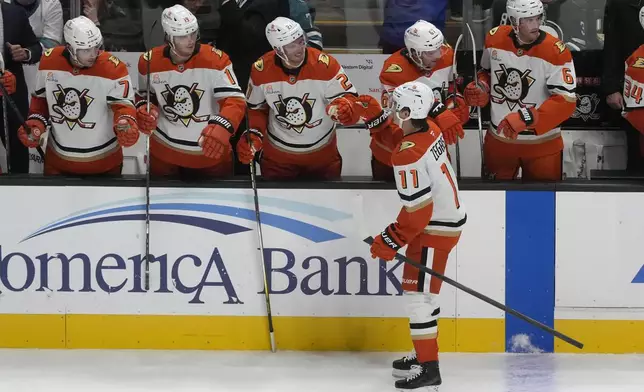 Anaheim Ducks center Trevor Zegras (11) is congratulated by teammates after scoring an empty net goal against the San Jose Sharks during the third period of an NHL hockey game in San Jose, Calif., Saturday, Oct. 12, 2024. (AP Photo/Jeff Chiu)