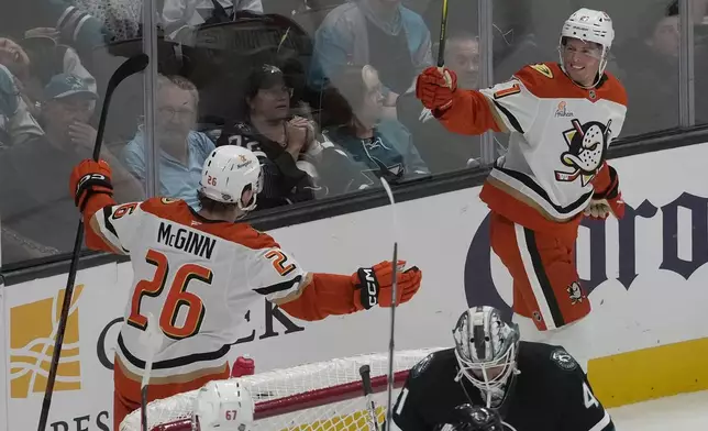 Anaheim Ducks center Isac Lundestrom, right, celebrates with left wing Brock McGinn (26) after scoring against the San Jose Sharks during the third period of an NHL hockey game in San Jose, Calif., Saturday, Oct. 12, 2024. (AP Photo/Jeff Chiu)