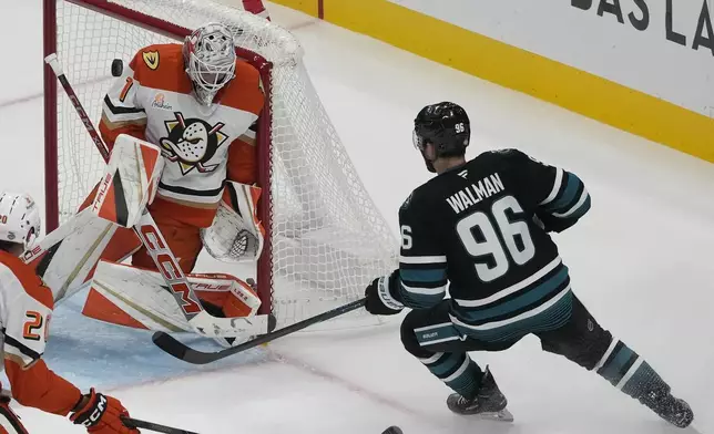 Anaheim Ducks goaltender Lukas Dostal, left, defends a shot next to San Jose Sharks defenseman Jake Walman (96) during the third period of an NHL hockey game in San Jose, Calif., Saturday, Oct. 12, 2024. (AP Photo/Jeff Chiu)