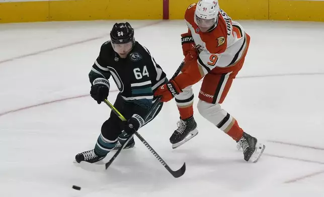 San Jose Sharks center Mikael Granlund (64) skates toward the puck against Anaheim Ducks center Leo Carlsson during the third period of an NHL hockey game in San Jose, Calif., Saturday, Oct. 12, 2024. (AP Photo/Jeff Chiu)