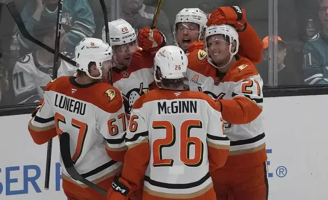 Anaheim Ducks center Isac Lundestrom, right, is congratulated by teammates after scoring against the San Jose Sharks during the third period of an NHL hockey game in San Jose, Calif., Saturday, Oct. 12, 2024. (AP Photo/Jeff Chiu)