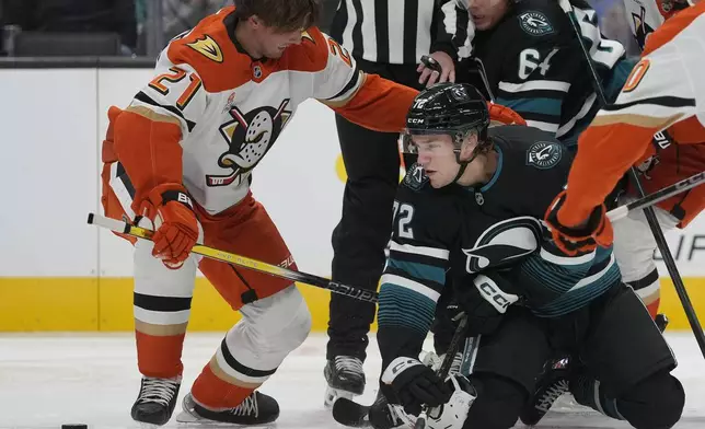 San Jose Sharks left wing William Eklund, front right, looks for the puck next to Anaheim Ducks center Isac Lundestrom (21) during the first period of an NHL hockey game in San Jose, Calif., Saturday, Oct. 12, 2024. (AP Photo/Jeff Chiu)