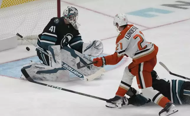 Anaheim Ducks center Isac Lundestrom (21) scores a goal past San Jose Sharks goaltender Vitek Vanecek (41) during the third period of an NHL hockey game in San Jose, Calif., Saturday, Oct. 12, 2024. (AP Photo/Jeff Chiu)