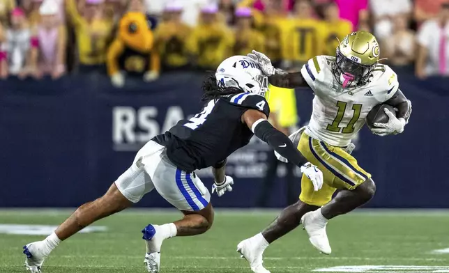 Georgia Tech Yellow Jackets running back Jamal Haynes (11) stiff arms Duke Blue Devils linebacker Cameron Bergeron (4) in the first quarter of a football game, Saturday, Oct. 5, 2024, in Atlanta. (AP Photo/Jason Allen)