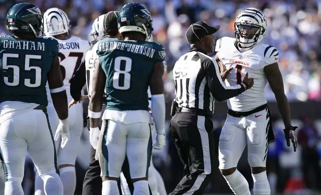 Official Anthony Flemming (90) intervenes in a conversation between Cincinnati Bengals wide receiver Ja'Marr Chase, right, and Philadelphia Eagles safety C.J. Gardner-Johnson (8) during the second half of an NFL football game, Sunday, Oct. 27, 2024 in Cincinnati. (AP Photo/Carolyn Kaster)